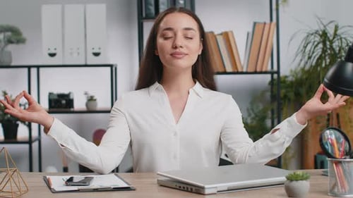 Businesswoman Working on Laptop Meditating Doing Yoga Breathing Exercise in Lotus Position at Office