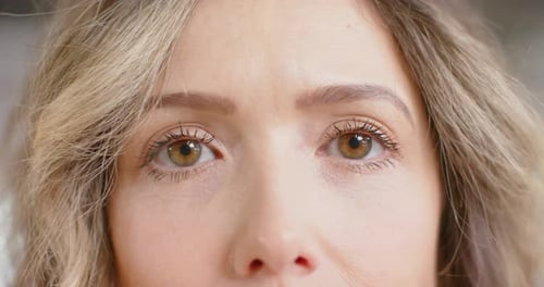 Portrait of happy eyes of caucasian casual businesswoman in office, slow motion