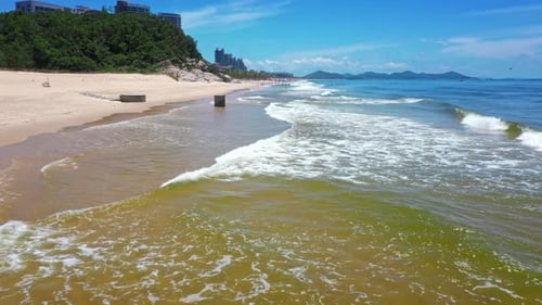 Aerial Top view of a transparent blue sea with beautiful waves at sunny day in summer. air of ocean