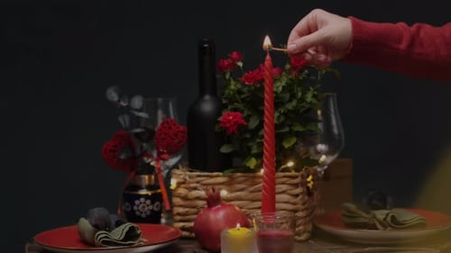 Lighting Candles on Romantic Dinner Table