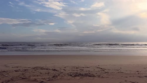 Waves Lap Empty Beach at Sunrise or Sunset
