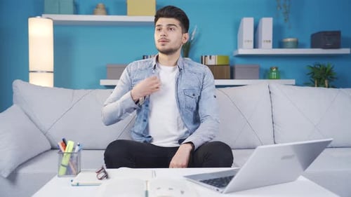 Young man sweating and suffocating from the summer heat.