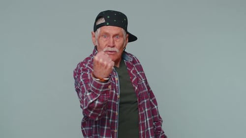 Senior Man Gesturing Angrily with a Fist