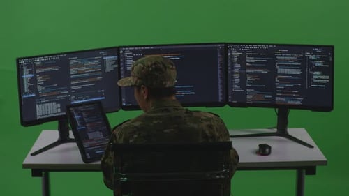 Man Soldier Developer Working With Tablet While Write Code With Multiple Screens In Green Screen