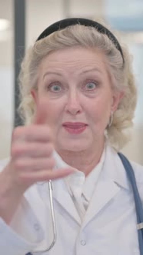 Smiling Senior Woman Doctor Gesturing Call Me