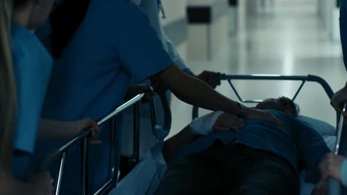 Emergency Department: Doctors, Nurses and Surgeons Push Gurney / Stretcher with Seriously Injured P