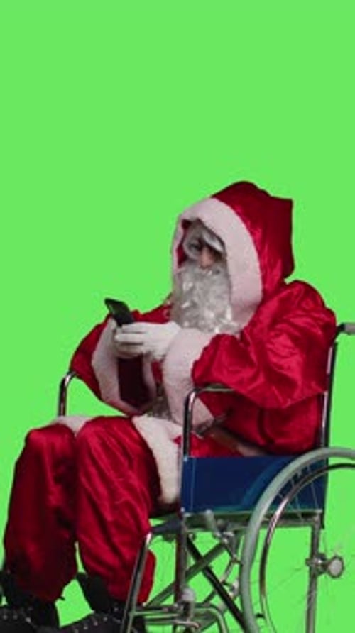 Vertical Video Side View of Santa Texting and Being on Videocall