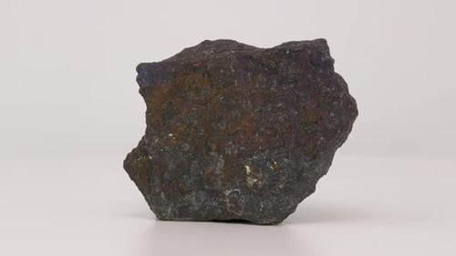Very close of Bornite. Peacock ore specimen. Rotating back to front.