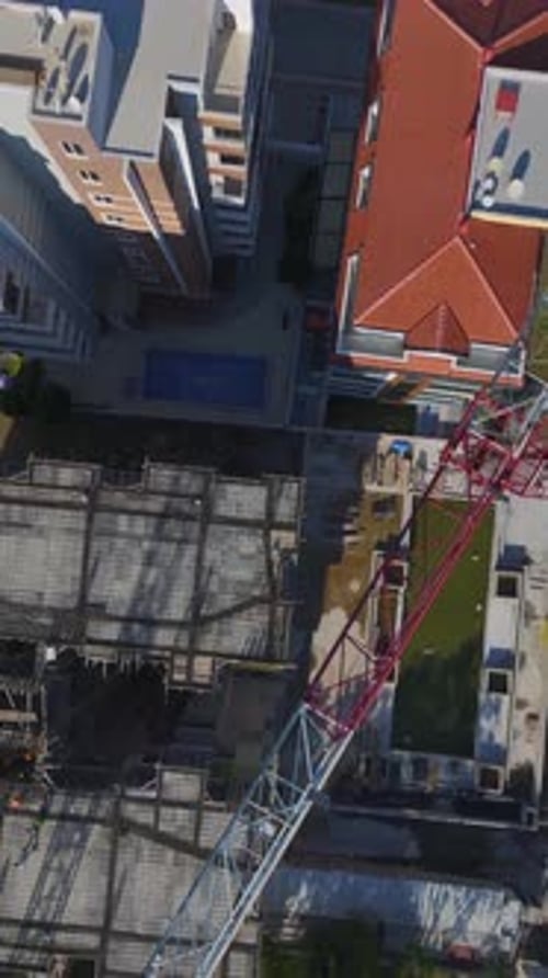 Vertical Video of Engineers Supervising Metal Framework Assembly on a Residential Site