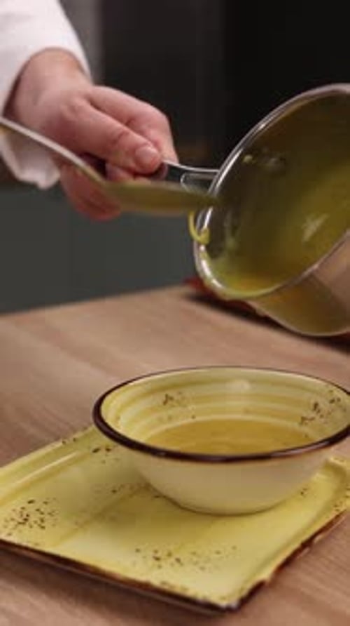 The chef is preparing a puree soup in the kitchen. Close-up