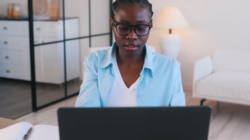 Woman Works at Laptop Computer at Home Office