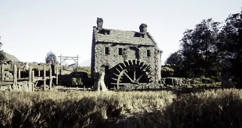 Historic Watermill Surrounded By Golden Fields at Sunset