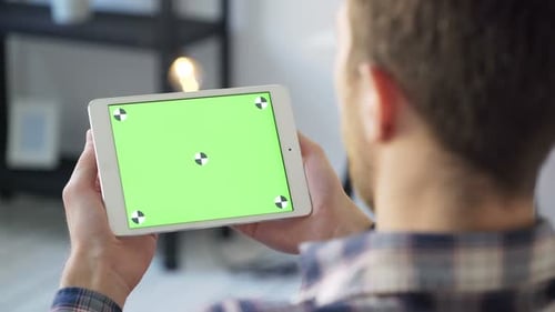 Young man at office using tablet pc with chroma key technology for video conference