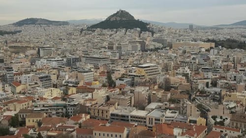 Aerial tilt down shot of the Mt Lycabettus and the city of Athens
