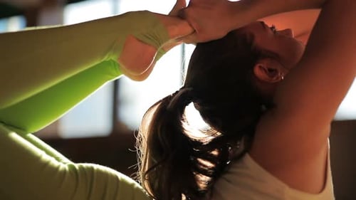 One Beautiful 30s Female Trainer Doing Asanas on Matting in Yogas Studio