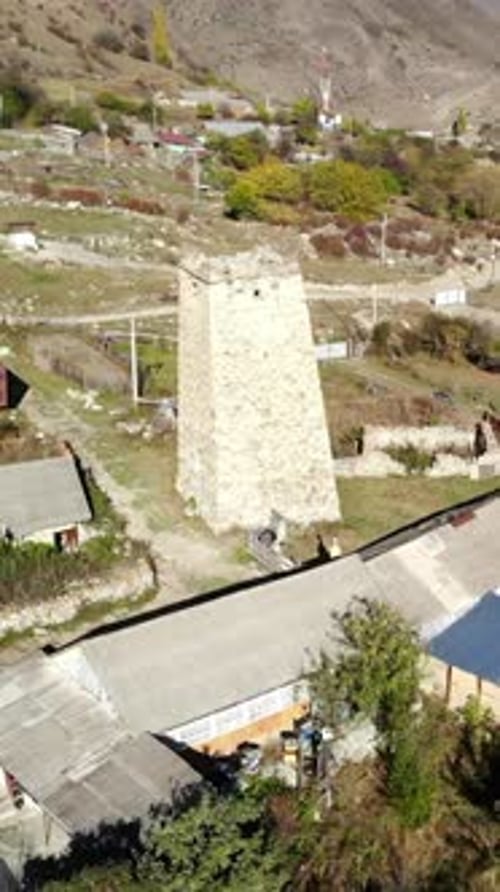 Aerial View of Ancient Stone Tower in Mountain Village Media