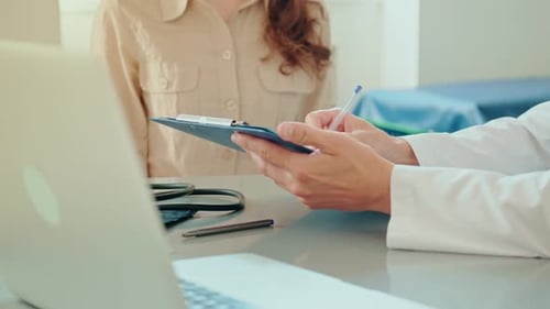 Doctor Consults Patient and Takes Notes