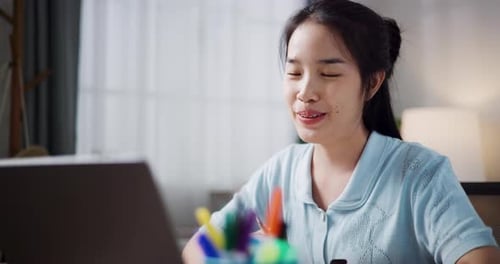 Woman Video Chats on Laptop at Home