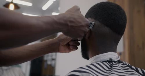 Man Getting Haircut at Modern Barber Shop