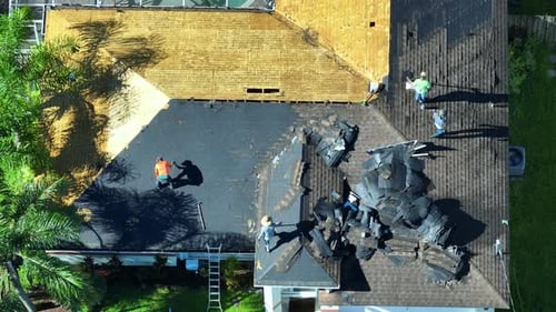 Workers Changing Old Asphalt Shingles to New on Private House Rooftop Roof Repair on Florida Home