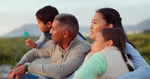 Relax, happy and sunset with family at beach for love, embrace and seaside adventure