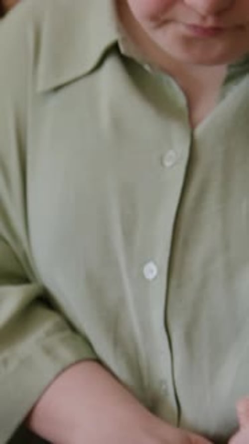 Close-up of Person with Down Syndrome Marking Leather with Awl in Workshop