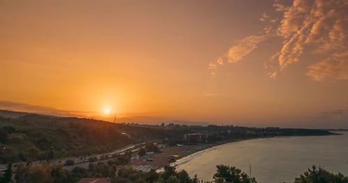 Picturesque Coastal Sunrise Over Calm Beach and Ocean