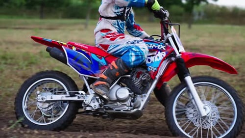Girl on Motocross Bike Racing on Dirt Off-road Track in Slow Motion During Competition