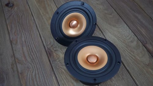 Copper Cone Audio Speakers on Wood Surface