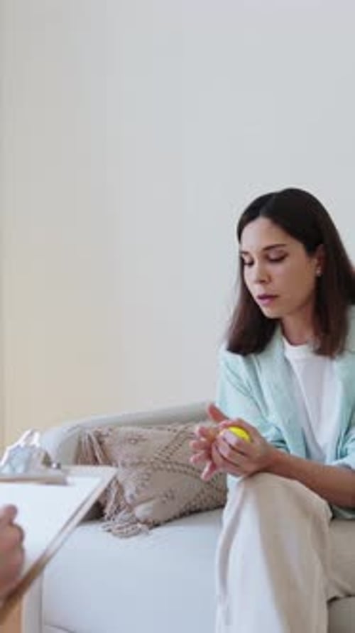 Woman Squeezing Stress Ball During Therapy Session