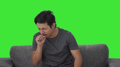 Sick Indian man suffering from cold and cough Green screen