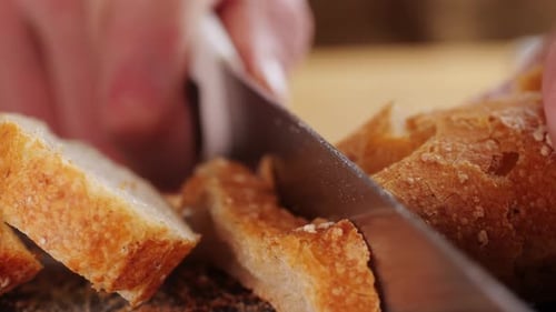 Slicing a Crusty Bread Loaf with Knife