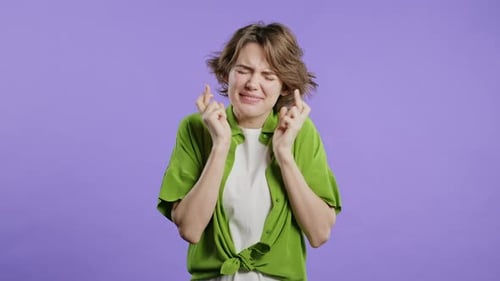Woman Crossing Fingers Hoping for Good Luck