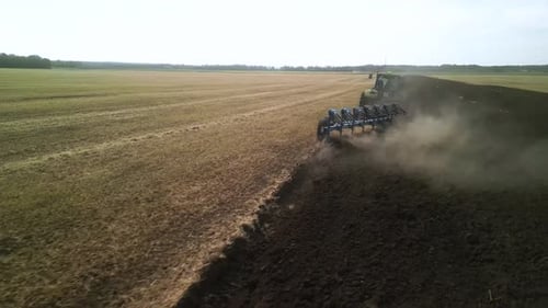 Tractors plowing the field in Ukraine