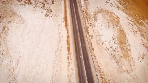 Car driving on Straight line Highway in the desert aerial view
