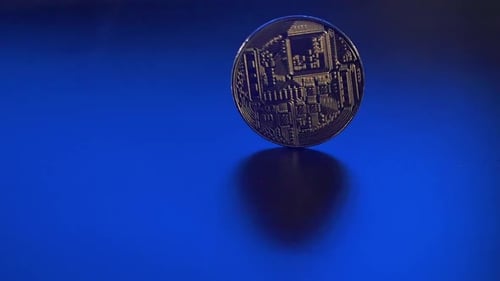 One Isolated Gold Cryptocurrency Coin Are Spinning on the Blue Background. Shining