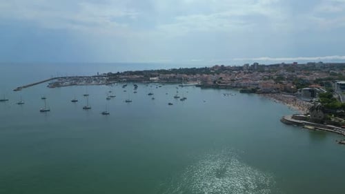 Aerial View Of Sailboats Anchored In Calm Bay Near Coastal Town