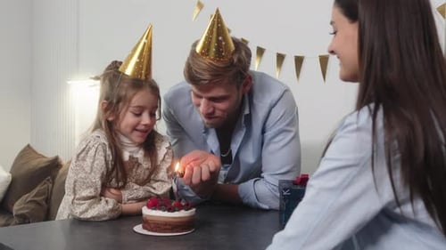 Family Celebrates a Birthday at Home With Cake