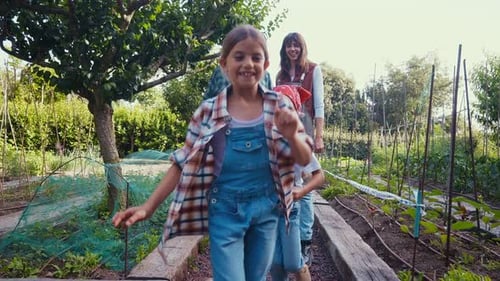 Happy Family Gardening Together on a Sunny Farm