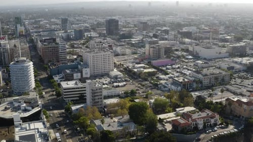 Slow tilt up over Vine Street and the 101 Freeway to reveal downtown Hollywood with south west Los A