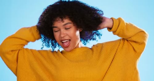 Happy black woman, dance and beauty in studio by blue background for fashion, smile and cheerful