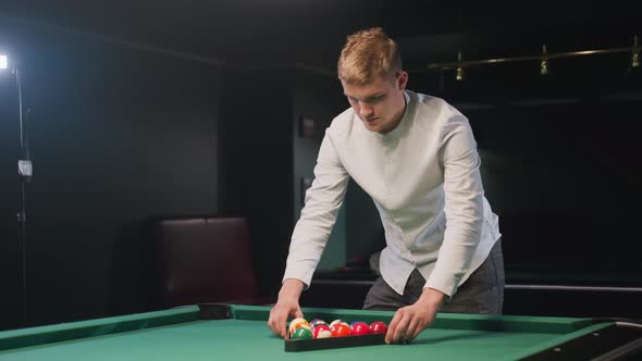 Billiard Trainee Arranging Balls in Triangle Formation on Green Pool ...