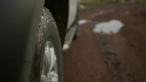 Wheels of Pickup Car Driving on Mud Path on Way to Wild Nature Beauty Spot