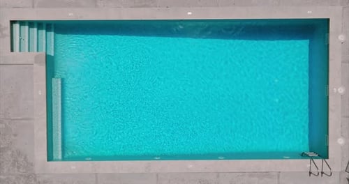 Blue Water in the Swimming Pool with Light Reflections