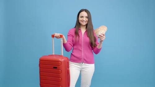 Smiling Woman with Suitcase and Money