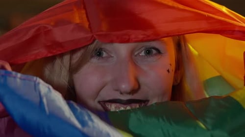 Close Up of Young Adult Under Pride Flag
