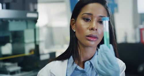 Woman Scientist Analyzing Test Tube in Laboratory