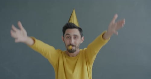Man Celebrates With Party Horn and Dancing