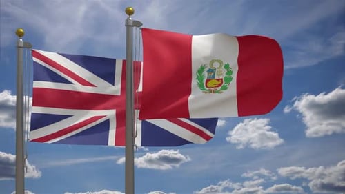 United Kingdom and Peru Flags Waving on Flagpoles against Blue Sky