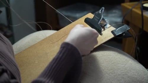 Hands Threading Needle for Crafting and Artistry